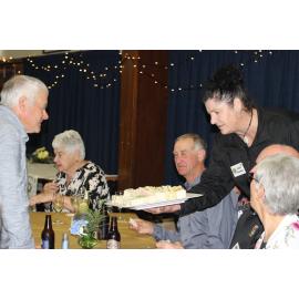 Jude Gamble hands out sandwiches at Lions 50th
